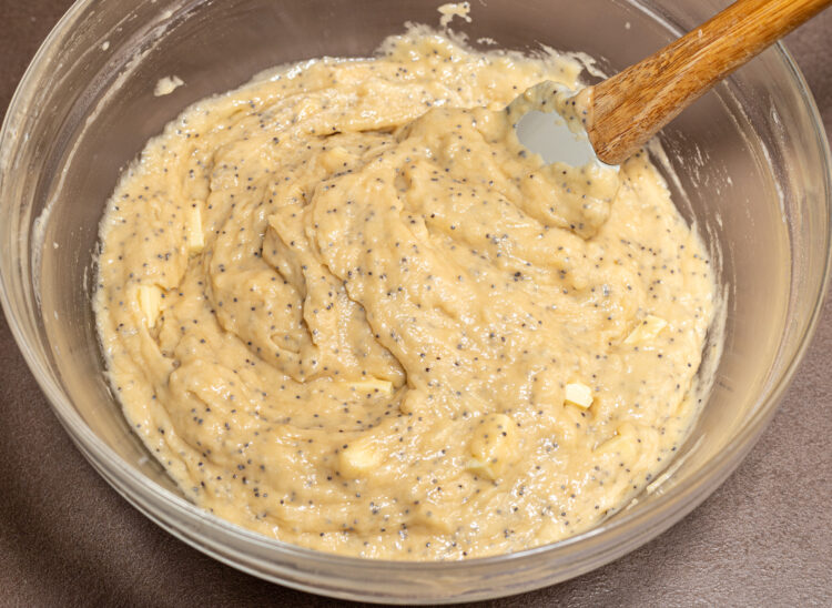 Bowl with white chocolate poppy seed batter.