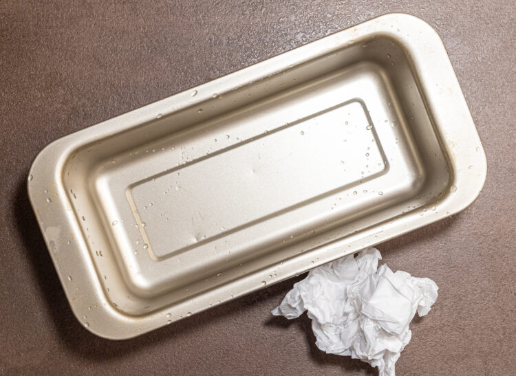 Baking dish with crinkled baking paper on the side.