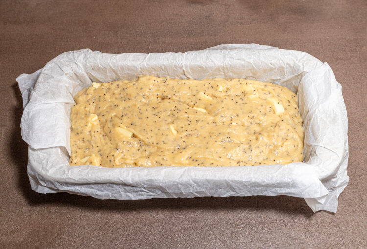 White chocolate poppy seed sweet bread batter in a baking dish.