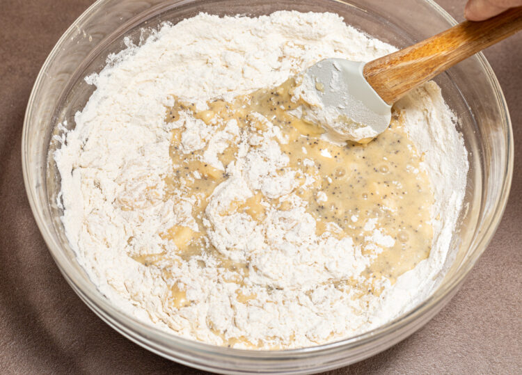Mixing wet and dry ingredients in a bowl.