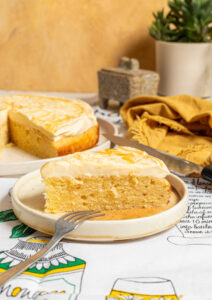 Slice of one-layer citrus cake with honey cream cheese frosting.