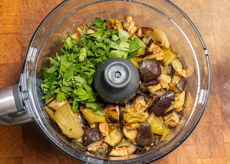 Roasted veggies and fresh parsley in a food processor.