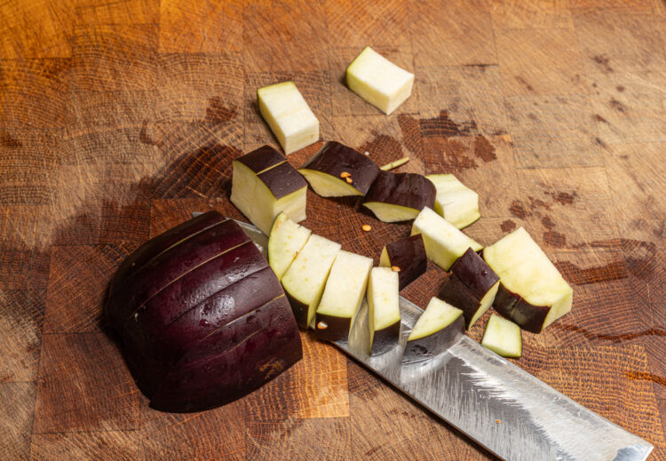 Chopping eggplant.
