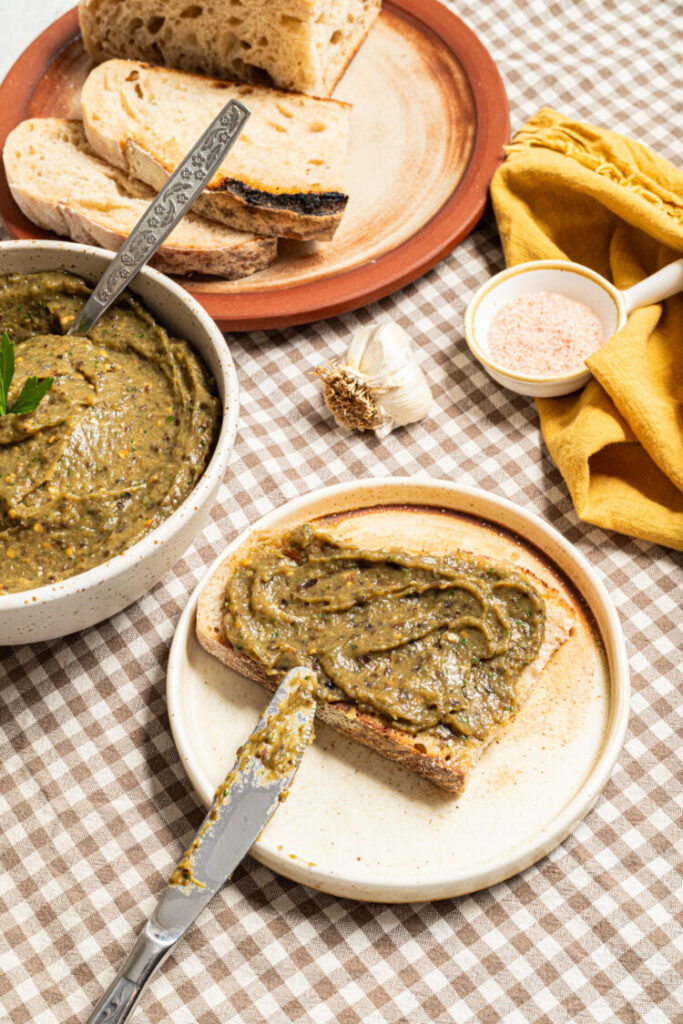 Roasted veggie spread on a slice of bread.