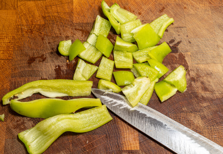 Chopping green sweet pepper.