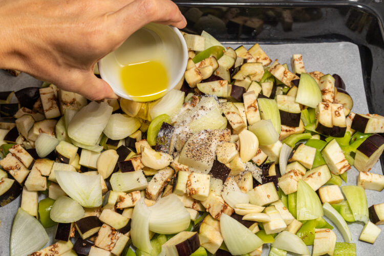 Seasoning chopped veggies.