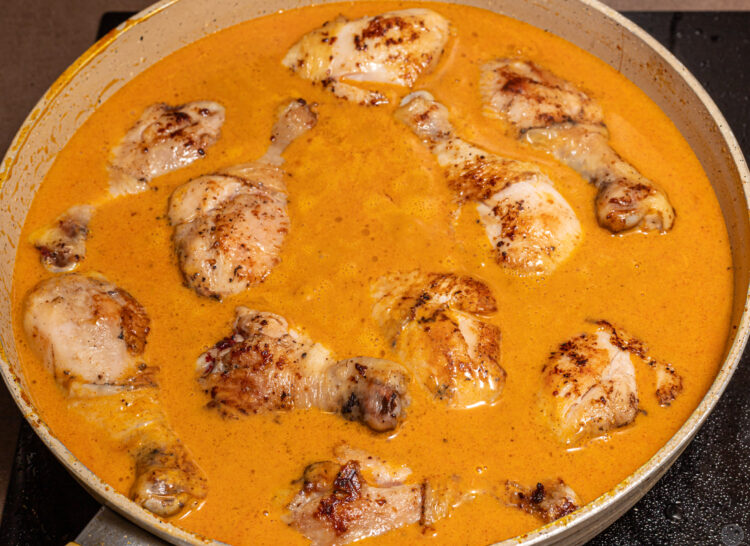 Chicken drumsticks in a curry sauce.