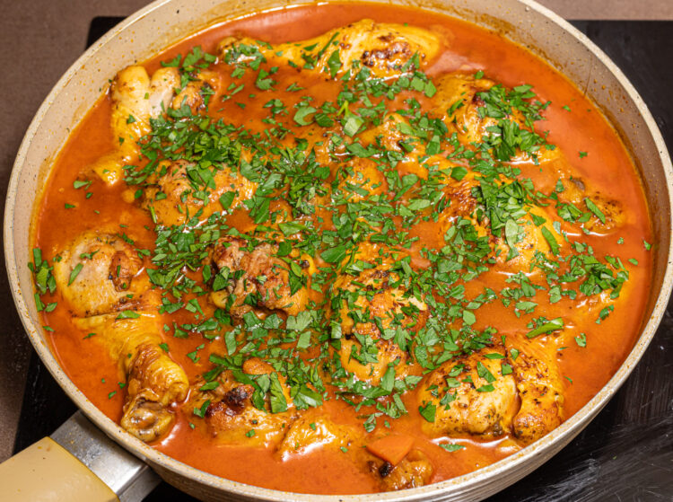 Fresh chopped parsley sprinkled on top of chicken coconut curry.