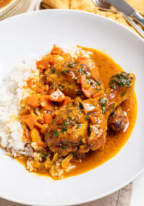 Chicken coconut curry with rice on a plate.