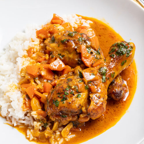 Chicken coconut curry with rice on a plate.
