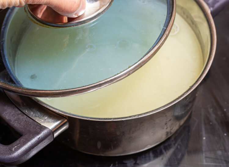 Covering a pot with a lid.