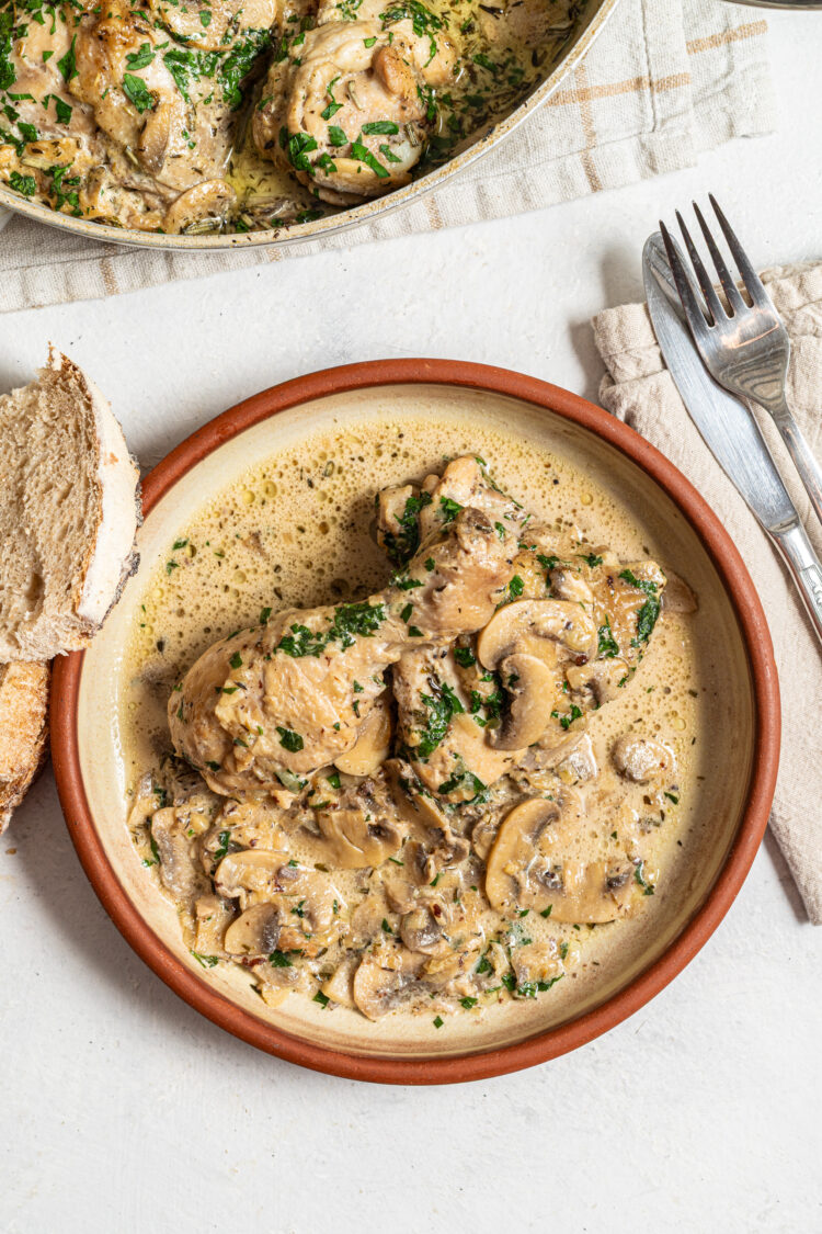 Chicken with mushrooms on a plate.