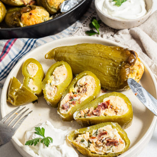Stuffed baked pepper sliced on a plate.