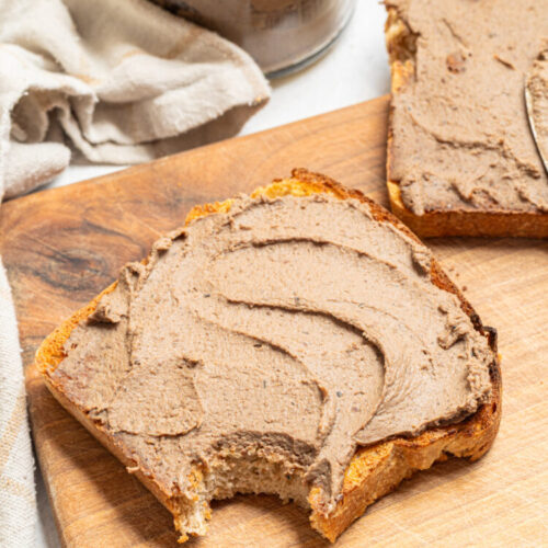 Chicken liver pate on toast with a bite off.